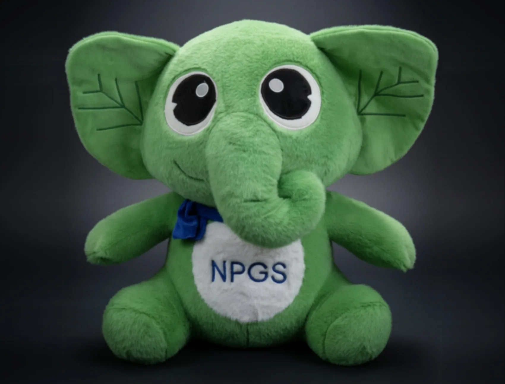 Green plush elephant with a printed tag