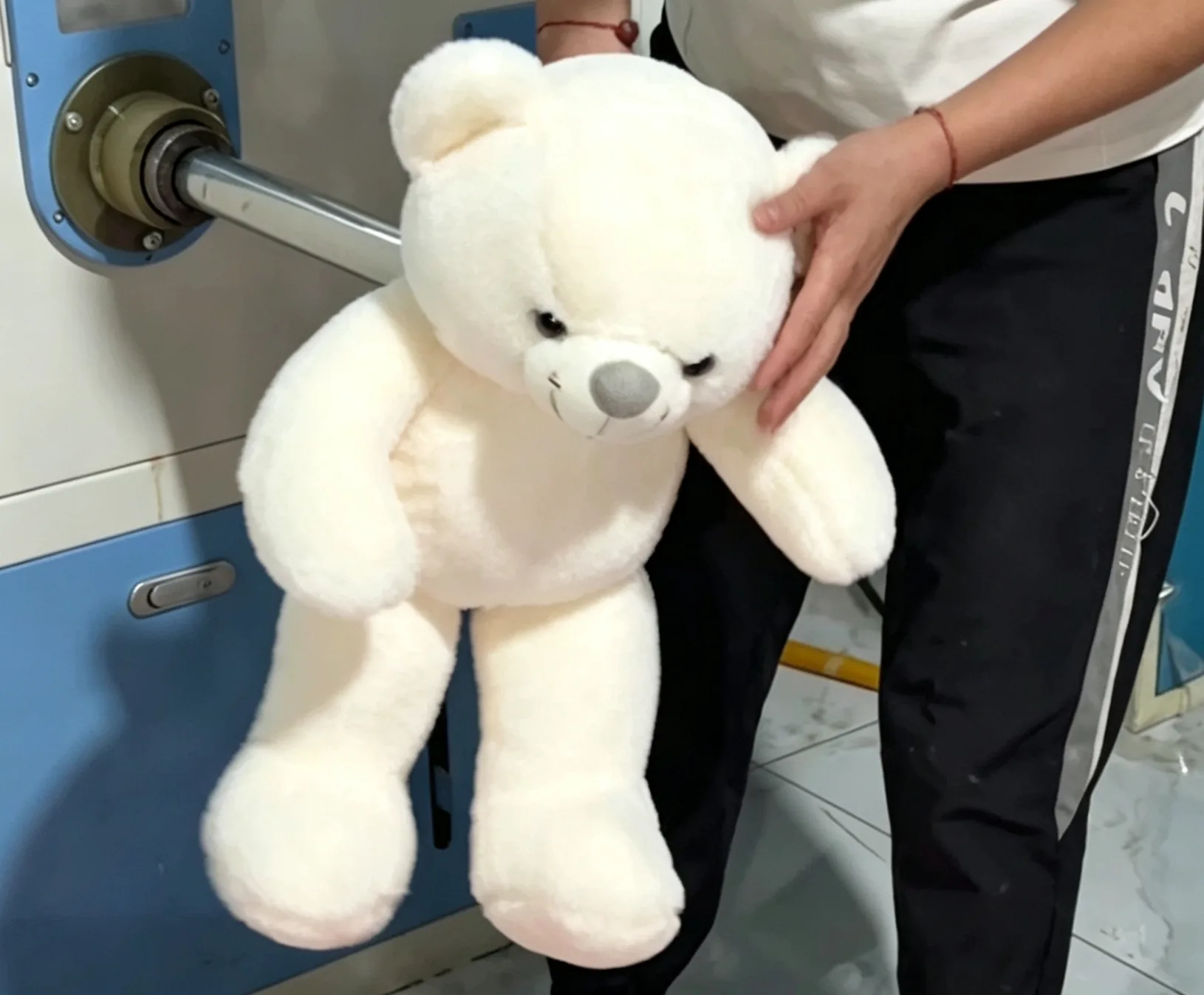 White plush bear checked during production