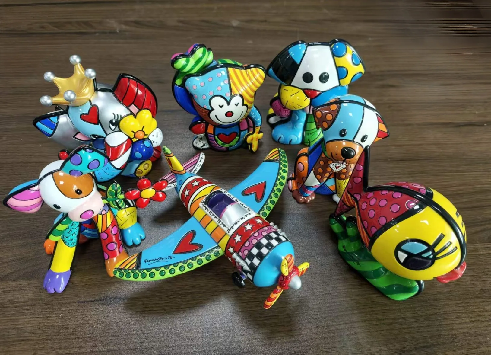 Hand-painted resin figures arranged for a production run